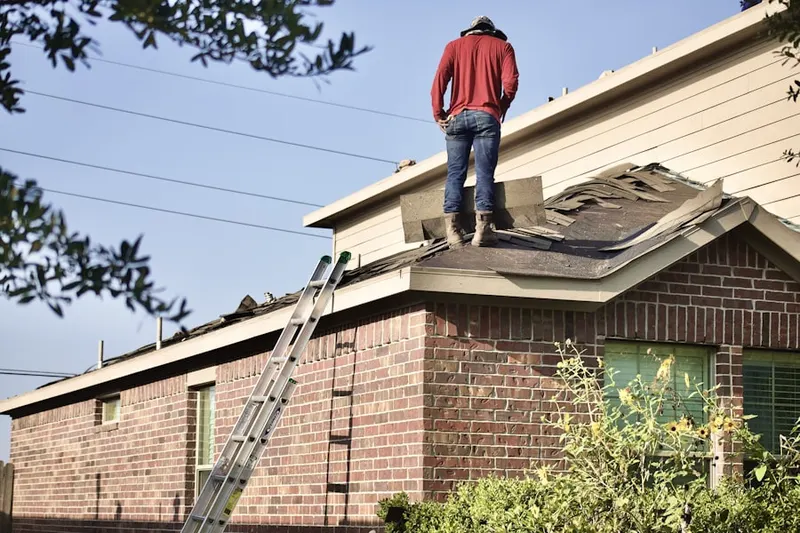 Professional roofer working on a residential roof in Downtown Apple Valley
